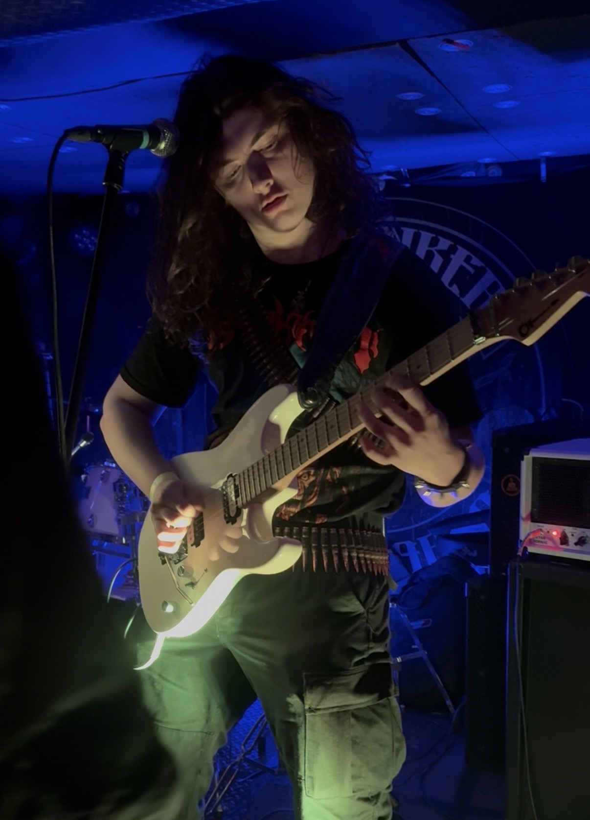 Jack Hynds, guitar instructor, playing a white electric guitar
